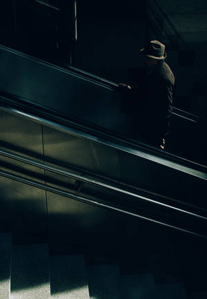 Anonymous Man In Escalator Wallpaper
