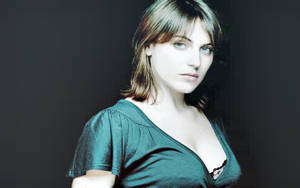 Antje Traue Posing Elegantly On A Grey Backdrop Wallpaper