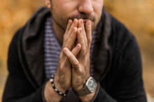 Anxious Man Contemplating Outdoors Wallpaper