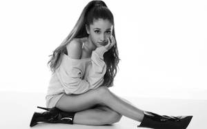 Ariana Grande Crossed Legs On Floor Wallpaper