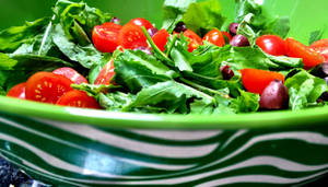 Arugula And Tomato Salad In Green Bowl Wallpaper