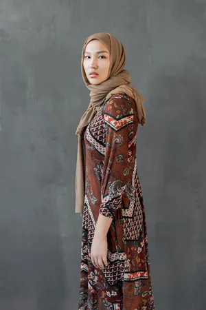 Asian Woman Wearing Stylish Brown Hijab Wallpaper