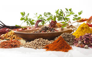 Assortment Of Ground And Whole Spices On Minimalist Background Wallpaper