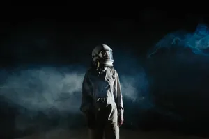 Astronaut In Space Wearing Gray Suit Wallpaper