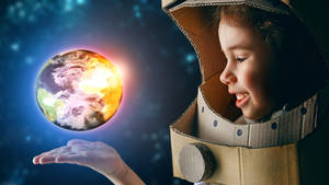 Astronaut Kid Holding Earth Wallpaper