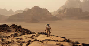 Astronaut Mark Watney Standing On The Rocky Terrain Of Mars. Wallpaper