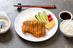 Authentic Tonkatsu Pork Cutlet With Fresh Cucumber Slices Wallpaper