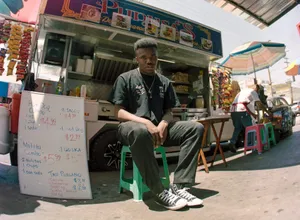 Baby Keem Near Food Truck Wallpaper