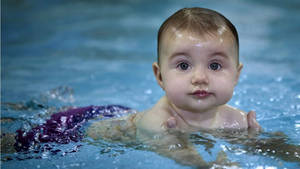 Baby On Swimming Lesson Wallpaper