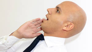 Bald Man Wearing A Black Necktie Wallpaper