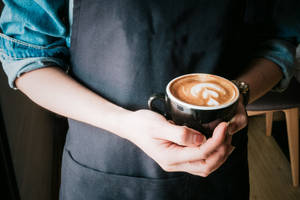 Barista Serving Coffee Aesthetic Wallpaper