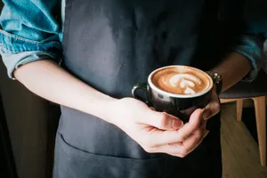 Barista Serving Coffee Aesthetic Wallpaper