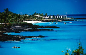 Beach In Comoros Surrounded By Rocks Wallpaper