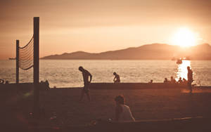 Beach Volleyball Net And Silhouette At Sunset Wallpaper