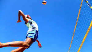 Beach Volleyball Player Jump Spike Wallpaper