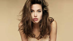 Beautiful Angelina Jolie In Beige Wallpaper