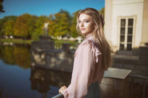 Beautiful Blonde Wearing A Pink Blouse Wallpaper