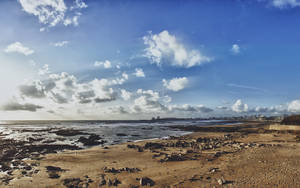 Beautiful Sky Over Rocky Beach Wallpaper