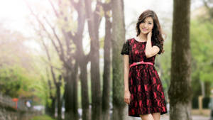 Beautiful Woman Posing At A Park Wallpaper