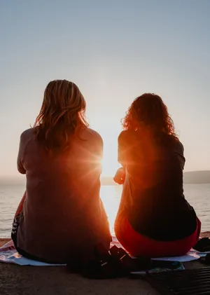 Best Friend At Beach In Sunset Wallpaper