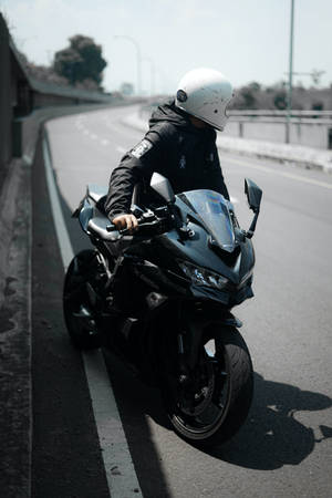 Bike Rider On A Black Motorcycle Wallpaper