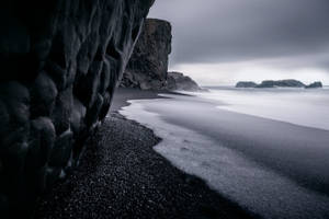 Black Sand And Sea Background Wallpaper