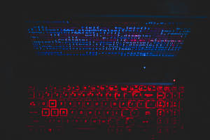 Blue Computer Screen And Red Keyboard Wallpaper