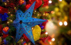 Blue Holiday Star On Christmas Tree Wallpaper