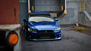 Blue Jdm Mitsubishi Evo X In Garage Wallpaper