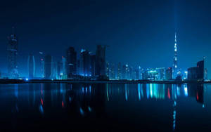 Blue Lit Dubai Skyline Buildings Wallpaper