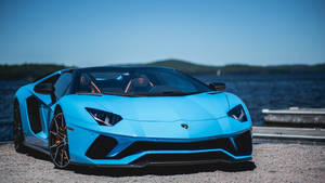 Blue Sports Car Near Water Wallpaper