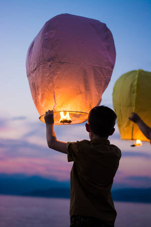 Boy And Flying Lantern Wallpaper