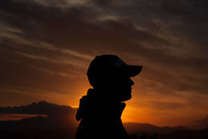 Boy In A Hoodie In A Golden Dusk Profile Wallpaper