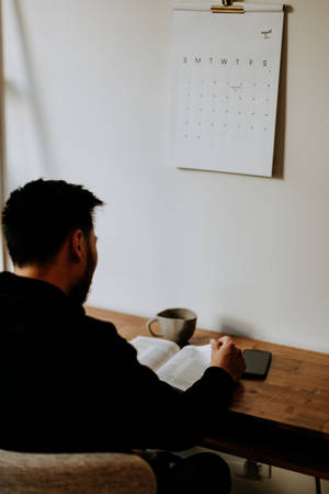 Boy Reading Book With Coffee Wallpaper