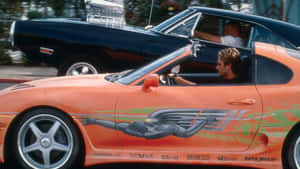 Brian Driving Car In Fast And Furious 1 Wallpaper