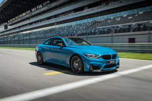 Bright Blue Bmw M4 Coupé Circuit Wallpaper