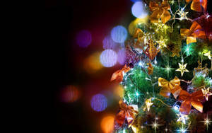 Bright Festive Christmas Tree With Ribbons And Stars Wallpaper