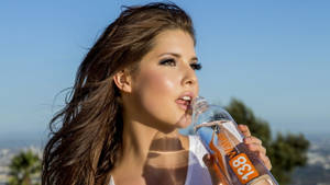 Brunette Woman Drinking Water From Bottle Wallpaper