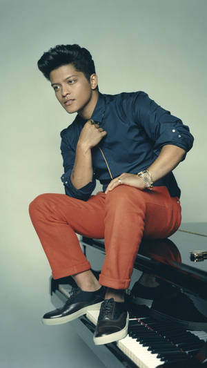 Bruno Mars Posing On Piano Wallpaper