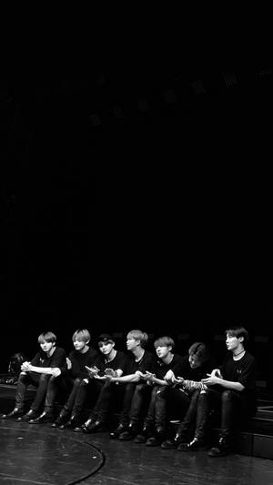 Bts Black Members Sitting Wallpaper