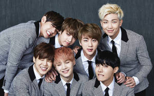 Bts Group Photo In Gray Suits Wallpaper