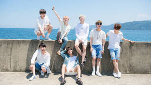 Bts Group Photo Near Ocean Wallpaper