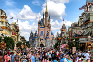 Bustling Disneyworld On A Sunny Day Wallpaper