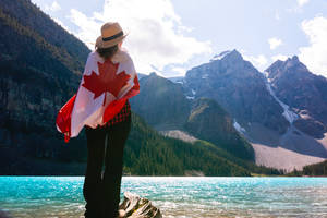 Canadian Flag Woman Staring At Mountains Wallpaper