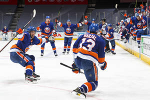 Canadian Ice Hockey Player Mathew Barzal Celebrating With Teammates Wallpaper