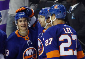 Canadian Ice Hockey Player Mathew Barzal With Teammates Wallpaper