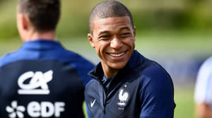 Candid Smiling Kylian Mbappe Wallpaper