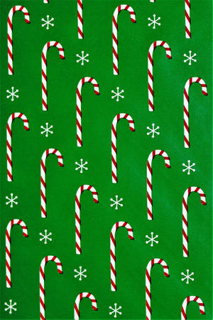 Candy Canes In Green Background Wallpaper