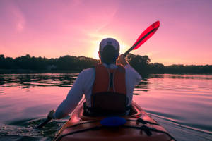 Canoeing In Purple Sunset Wallpaper