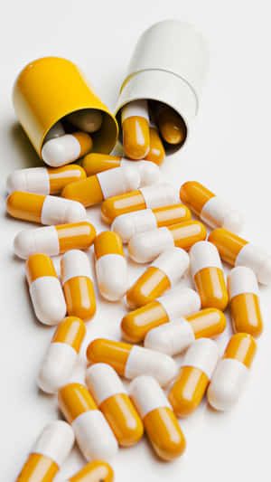 Capsules_ Spilled_ From_ Prescription_ Bottle Wallpaper